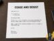 Plain cease-and-desist letter on a desk beside a remote