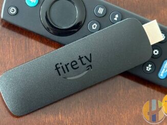 Amazon Fire TV Stick and remote on wood table; Fire TV Beta Access Program September 2026