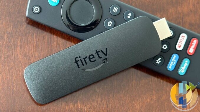 Amazon Fire TV Stick and remote on wood table; Fire TV Beta Access Program September 2026