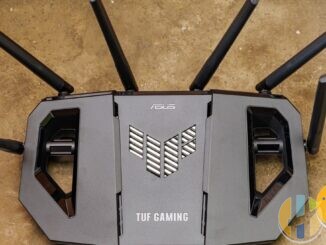 Real ASUS TUF gaming Wi-Fi router on a wooden desk — living-room router hardware that often decides whether a Google TV stick buffers or plays cleanly.