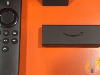 Living-room TV remote and streaming stick on a coffee table — generic home streaming setup, not a JustWatch brand shot.