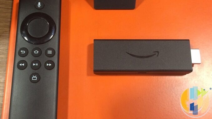 Living-room TV remote and streaming stick on a coffee table — generic home streaming setup, not a JustWatch brand shot.