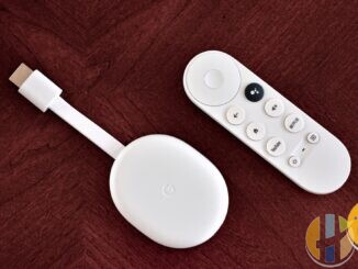 Real Chromecast with Google TV stick and remote on a desk — Freely-plus-apps stack living-room hardware; no forged Sky Stream logos.