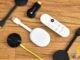Real collection of Chromecast streaming sticks and a Google TV remote laid out on a wooden desk — multi-generation stick hardware for side-by-side comparison context; no Strong or Xiaomi forged marks.