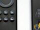 Amazon Fire TV Stick and Alexa Voice Remote close-up on white surface, husham.com stamp, September 2026