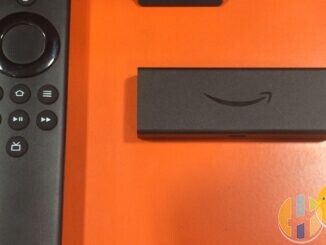 Real Amazon Fire TV Stick and Alexa Voice Remote on an orange display surface — everyday second-room streaming stick alternative; no TalkTalk or YouView forged marks.
