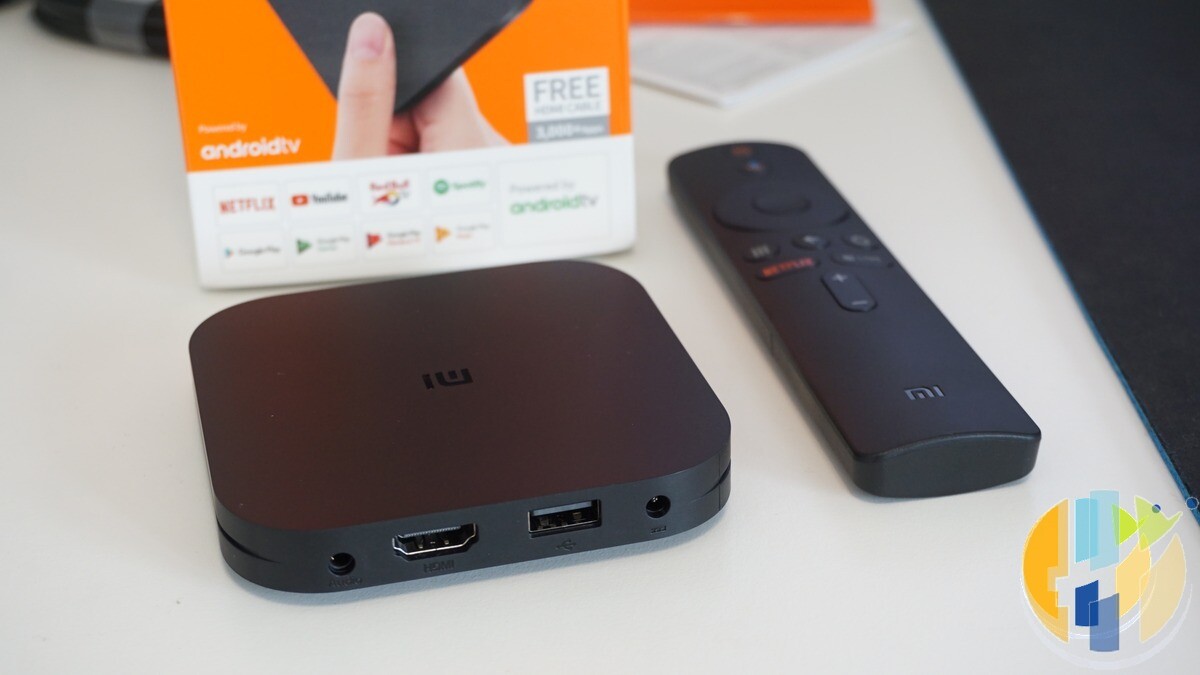 Real Xiaomi Mi Box S Android TV box with remote on a white desk — generic Android TV entertainment hub without EE or NOW forged marks.