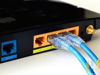 Two blue Ethernet cables plugged into the LAN ports on the back of a black home router