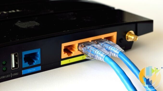 Two blue Ethernet cables plugged into the LAN ports on the back of a black home router