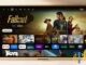 Amazon's new Fire TV home screen interface shown on a wall-mounted TV