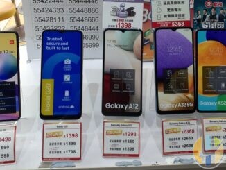 Redmi Note 10, Nokia G20 and Samsung Galaxy A12, A32 and A52 phones on display stands with price tags in a Hong Kong phone shop window