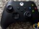 Black Xbox Series wireless controller with coloured A, B, X and Y buttons lying on a speckled granite worktop