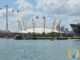 The O2 Arena dome in Greenwich, London, seen across the water with the cable car passing overhead