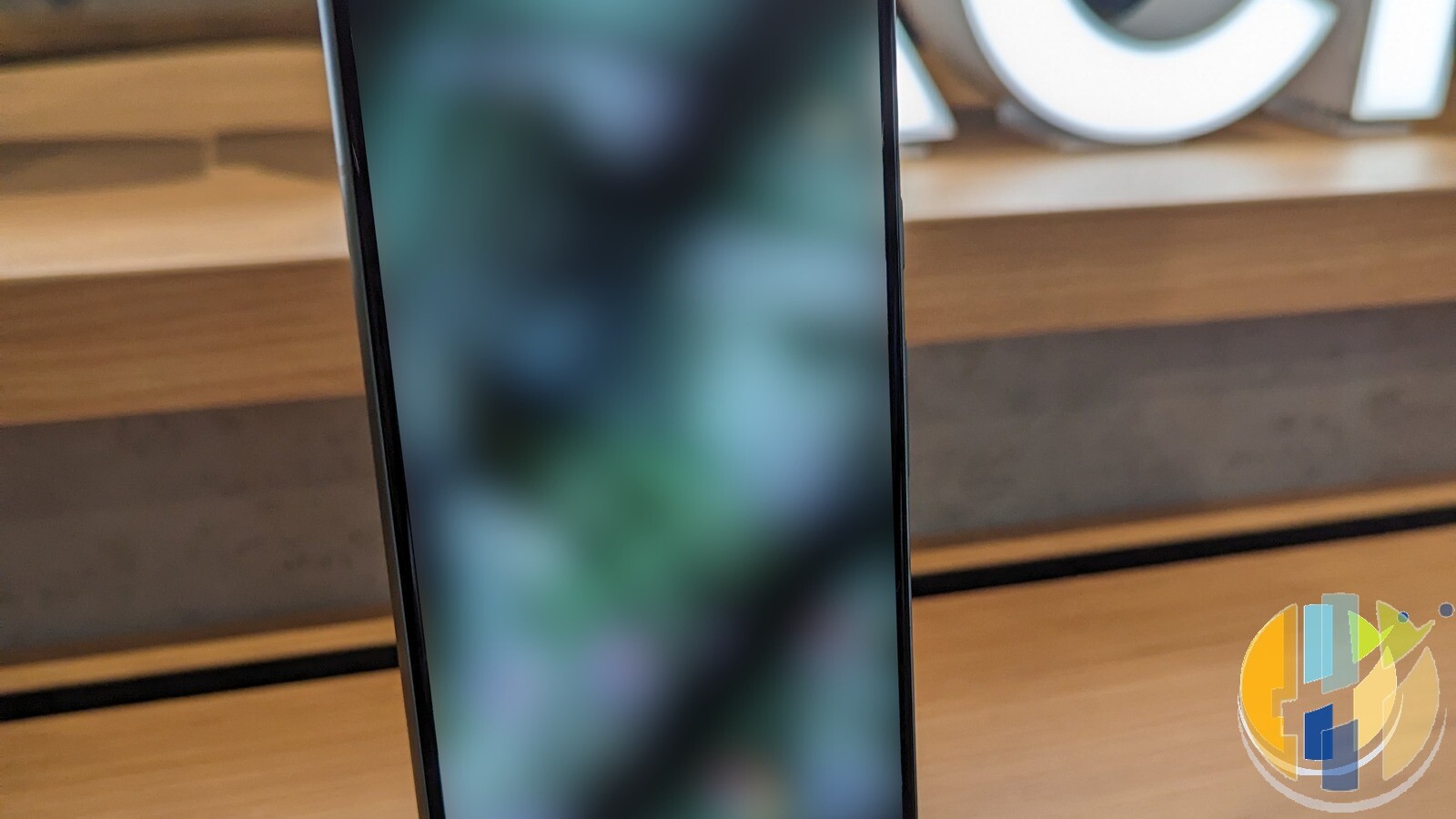 Google Pixel 8 smartphone standing on a wooden surface, used as a real phone photo for the Gemini Gems to skills prep checklist
